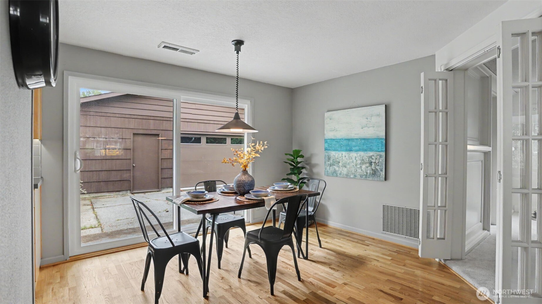 12515 Southeast 171st Street Renton, WA 98058 - Photo 13 of 24 a view of a dining room with furniture window and wooden floor