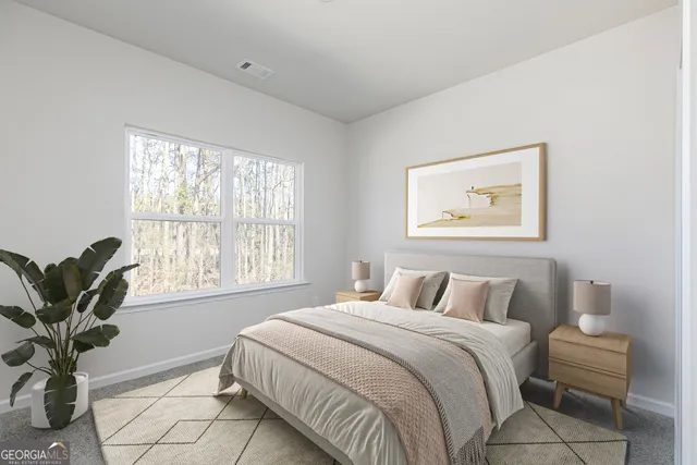 a bedroom with a large bed and a window