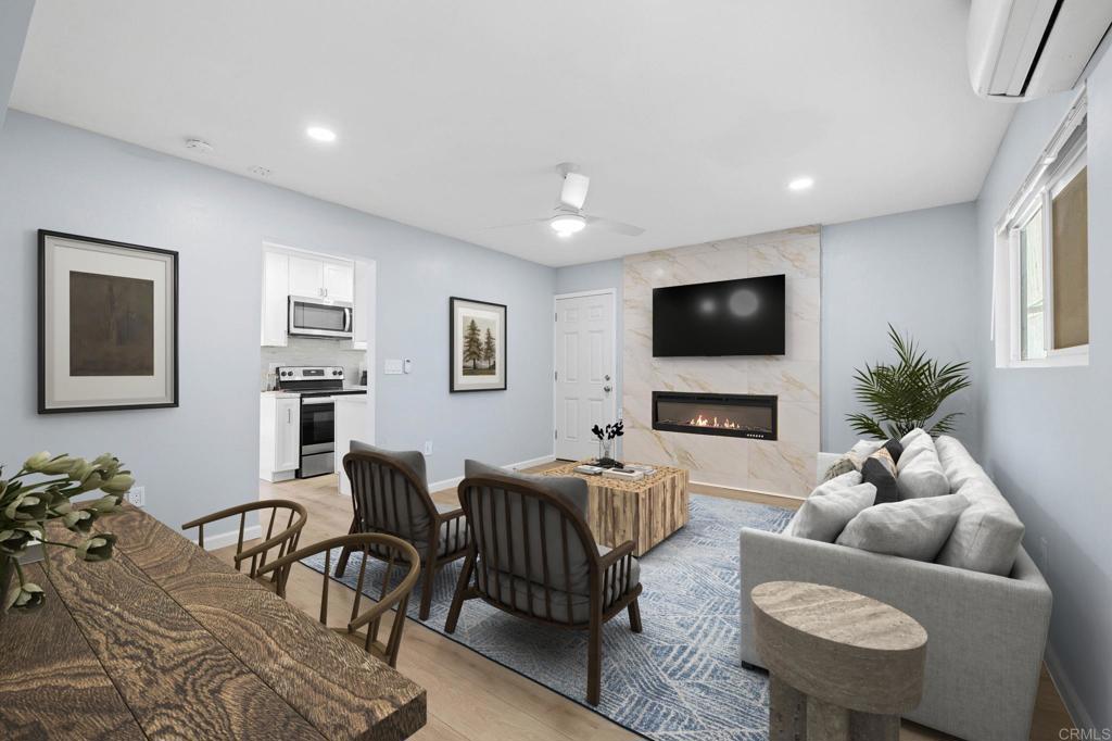 1908 Washington Street, Unit 2 Lemon Grove, CA 91945 - Photo 2 of 26 a living room with furniture a flat screen tv and a dining table