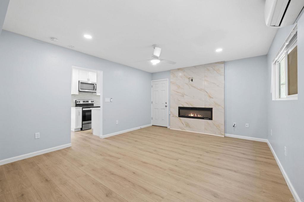 1908 Washington Street, Unit 2 Lemon Grove, CA 91945 - Photo 3 of 26 a view of an empty room with a fireplace and a window