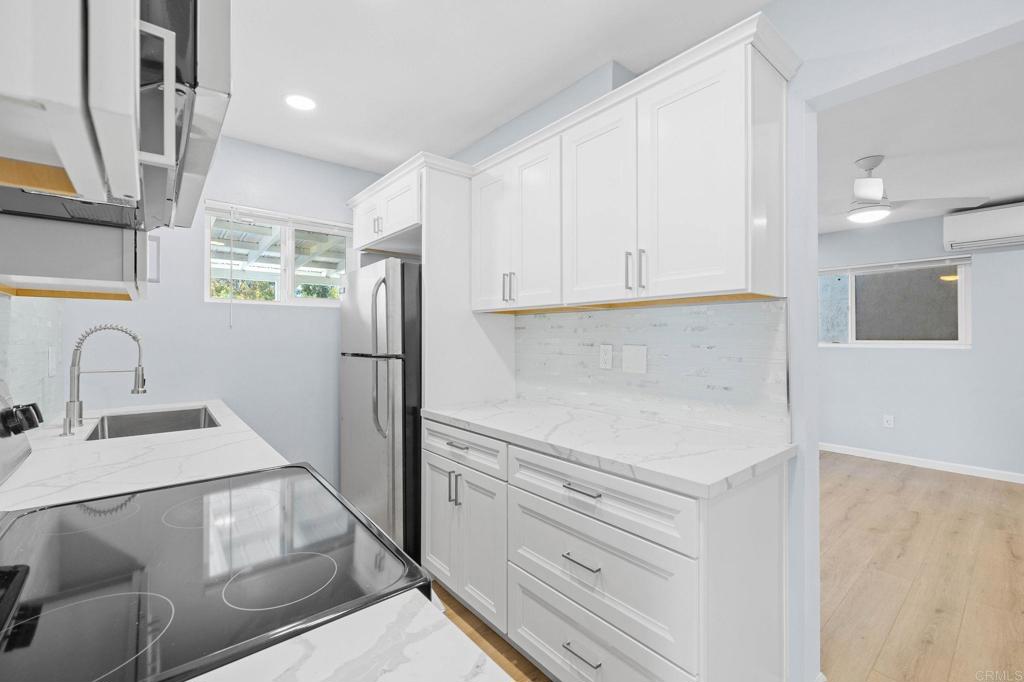 1908 Washington Street, Unit 2 Lemon Grove, CA 91945 - Photo 8 of 26 a kitchen with a refrigerator sink and cabinets