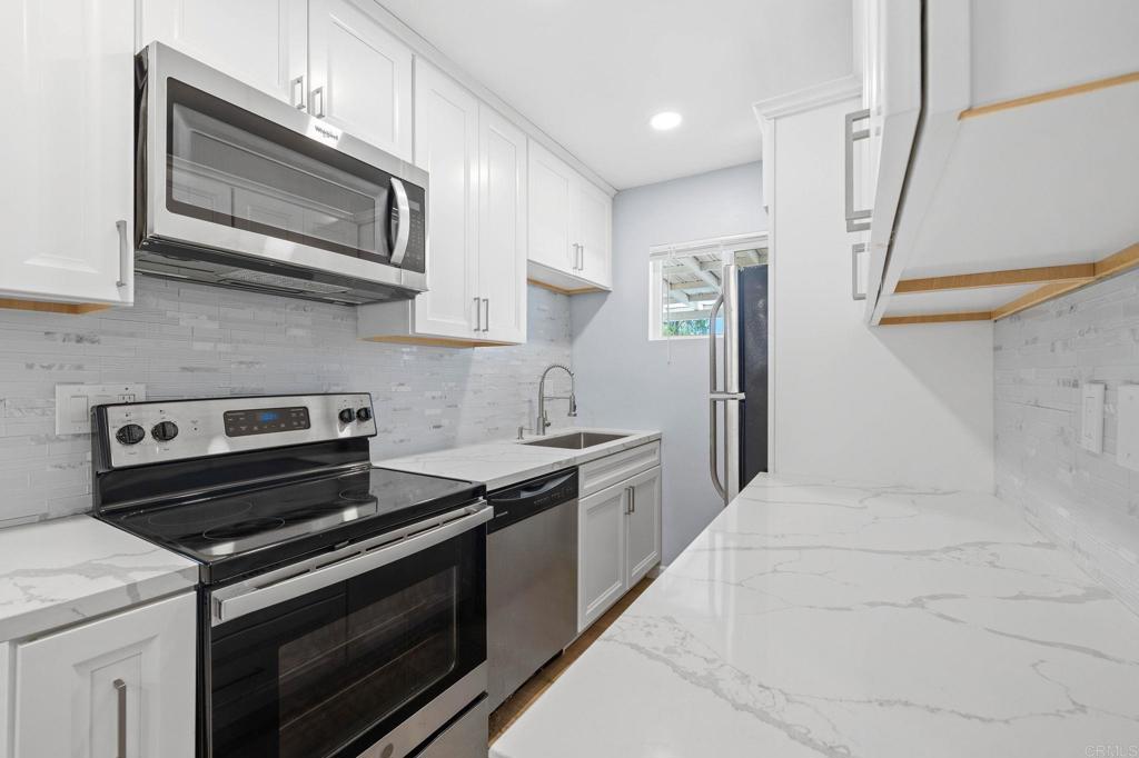 1908 Washington Street, Unit 2 Lemon Grove, CA 91945 - Photo 9 of 26 a kitchen with stainless steel appliances a stove microwave and sink