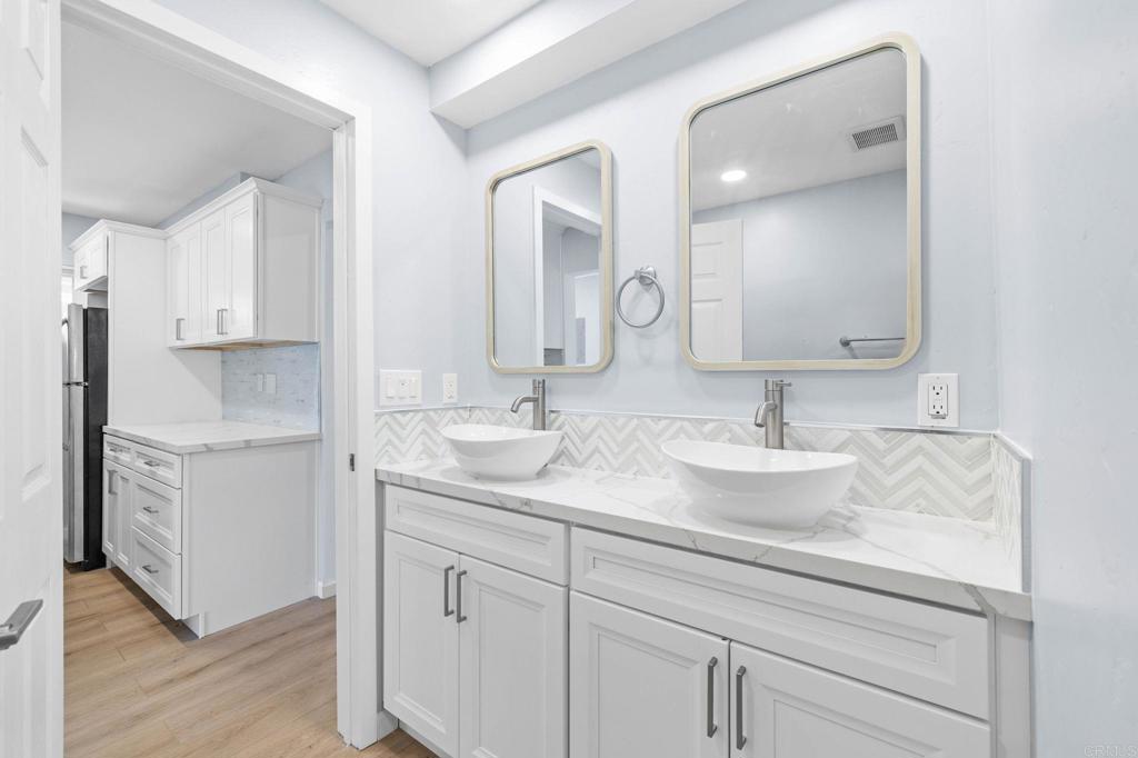 1908 Washington Street, Unit 2 Lemon Grove, CA 91945 - Photo 10 of 26 a bathroom with double sink and a mirror