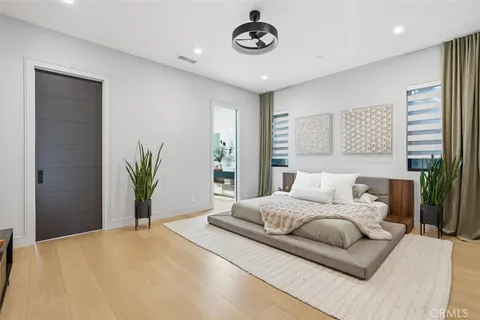 a bedroom with a bed and a chandelier