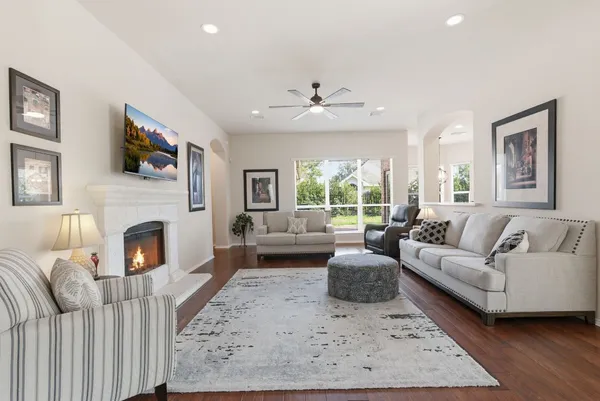 a living room with furniture a fireplace and a flat screen tv