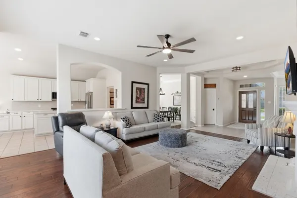 a living room with furniture and a wooden floor