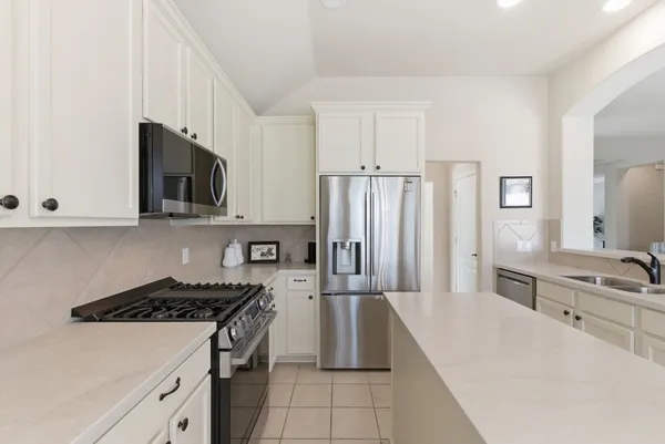 a kitchen with a stove a sink and a refrigerator