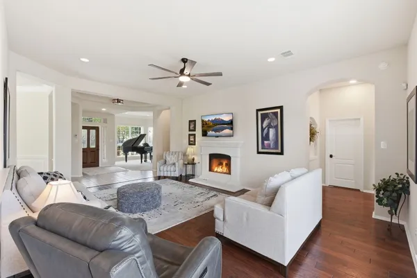 a living room with furniture and wooden floor