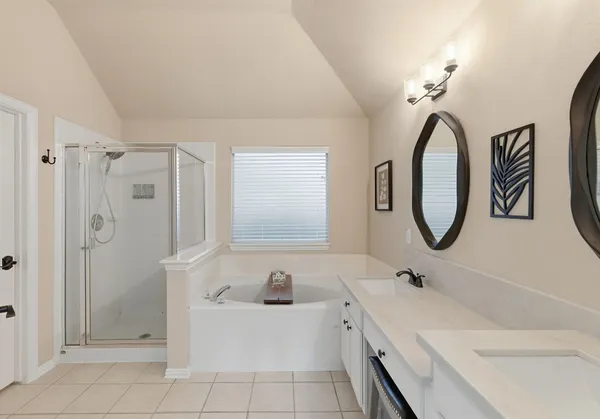 a bathroom with a double vanity sink mirror and a shower