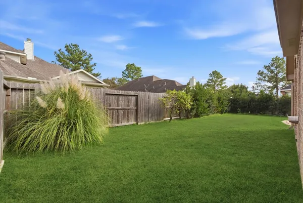 a yellow house with a yard in front of it
