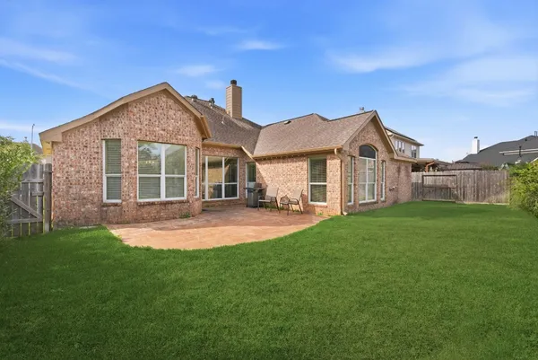 a front view of a house with yard and green space