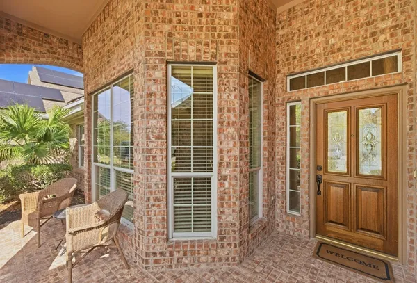 a front view of a house with a yard glass top table and chairs