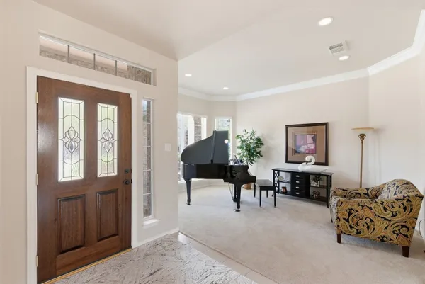 a living room with furniture and a chandelier