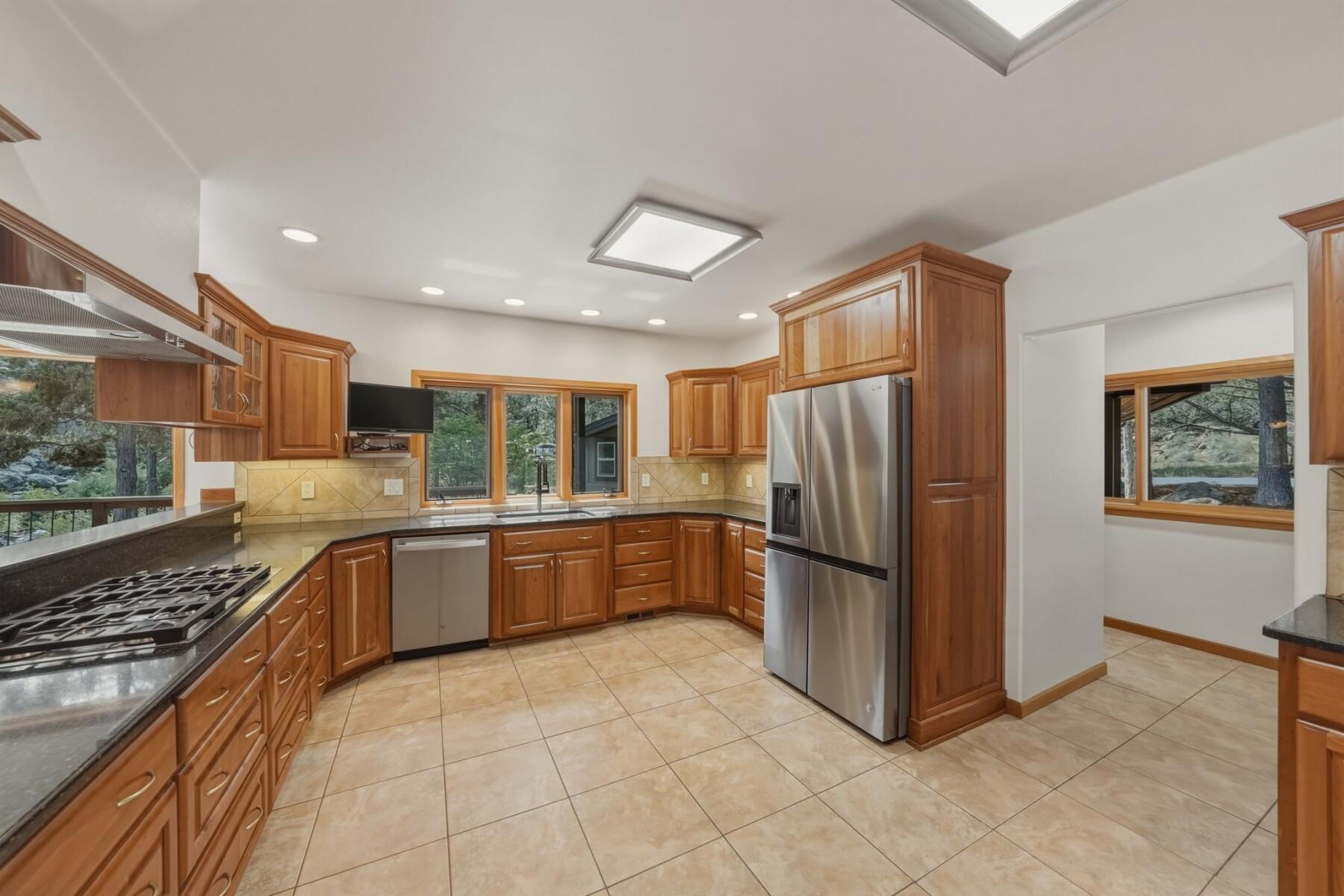 637 Northwest Silver Buckle Road Bend, OR 97703 - Photo 14 of 68 a large kitchen with a stove a refrigerator and a sink