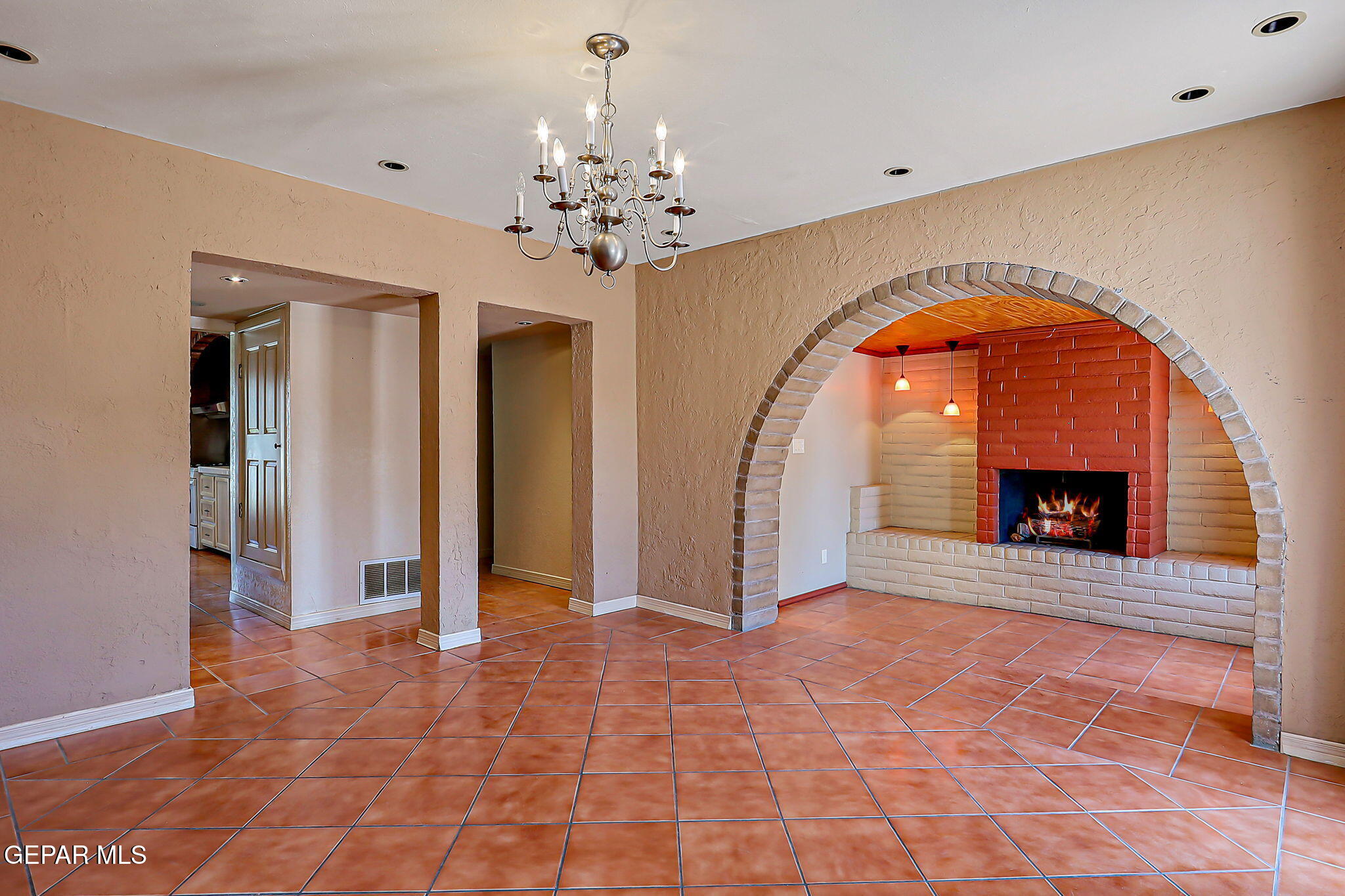 122 North Pendell Road El Paso, TX 79905 - Photo 27 of 62 a view of an empty room with a fireplace and a chandelier