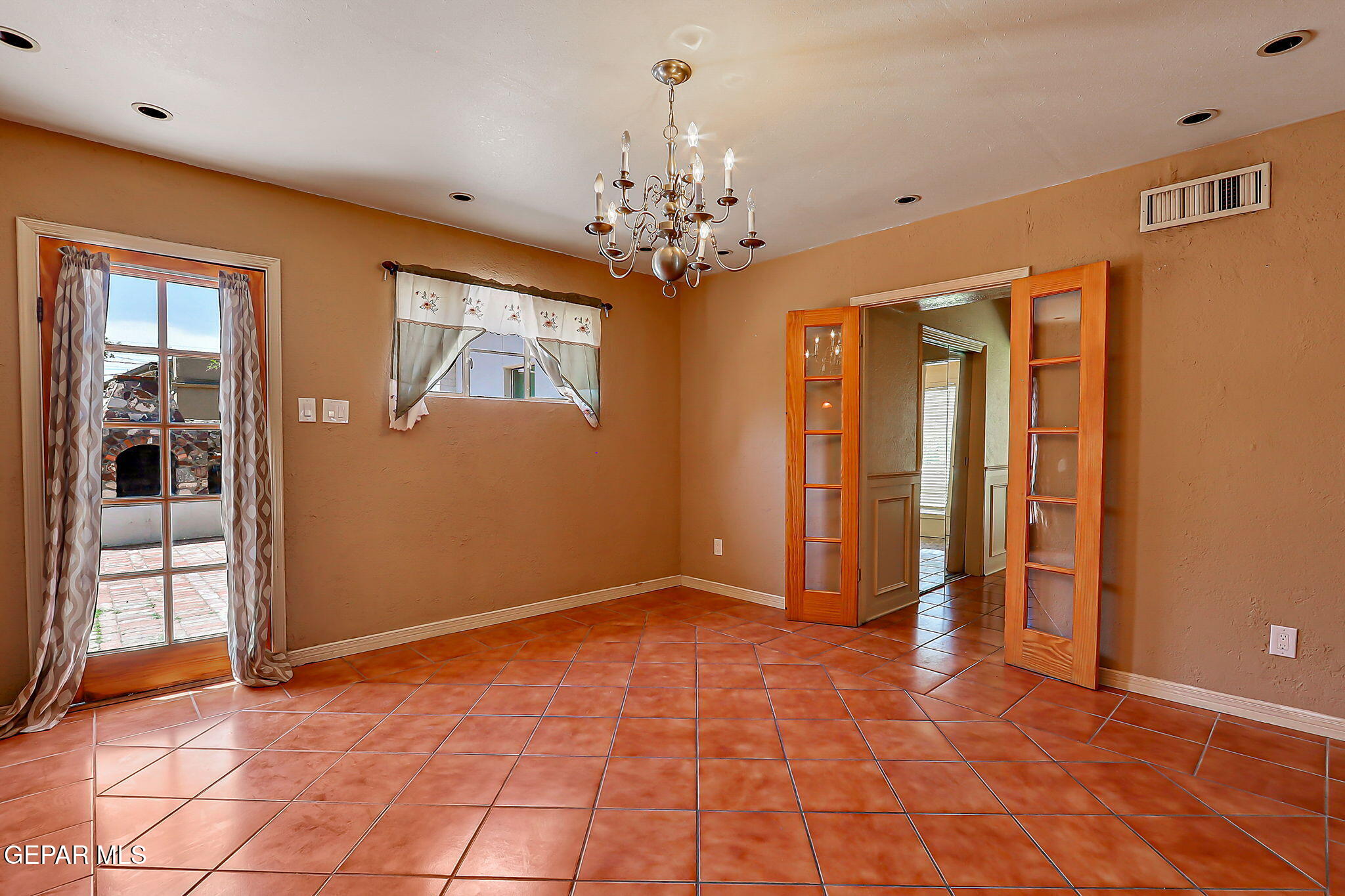 122 North Pendell Road El Paso, TX 79905 - Photo 30 of 62 a view of an empty room with window and chandelier