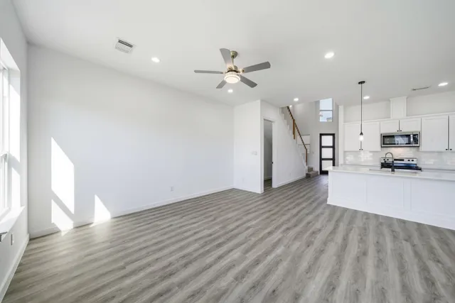 a view of a kitchen with wooden floor and a kitchen