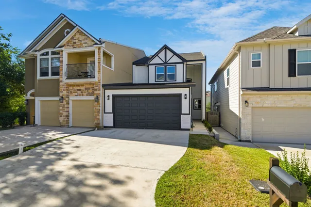 a front view of a house with a yard and garage