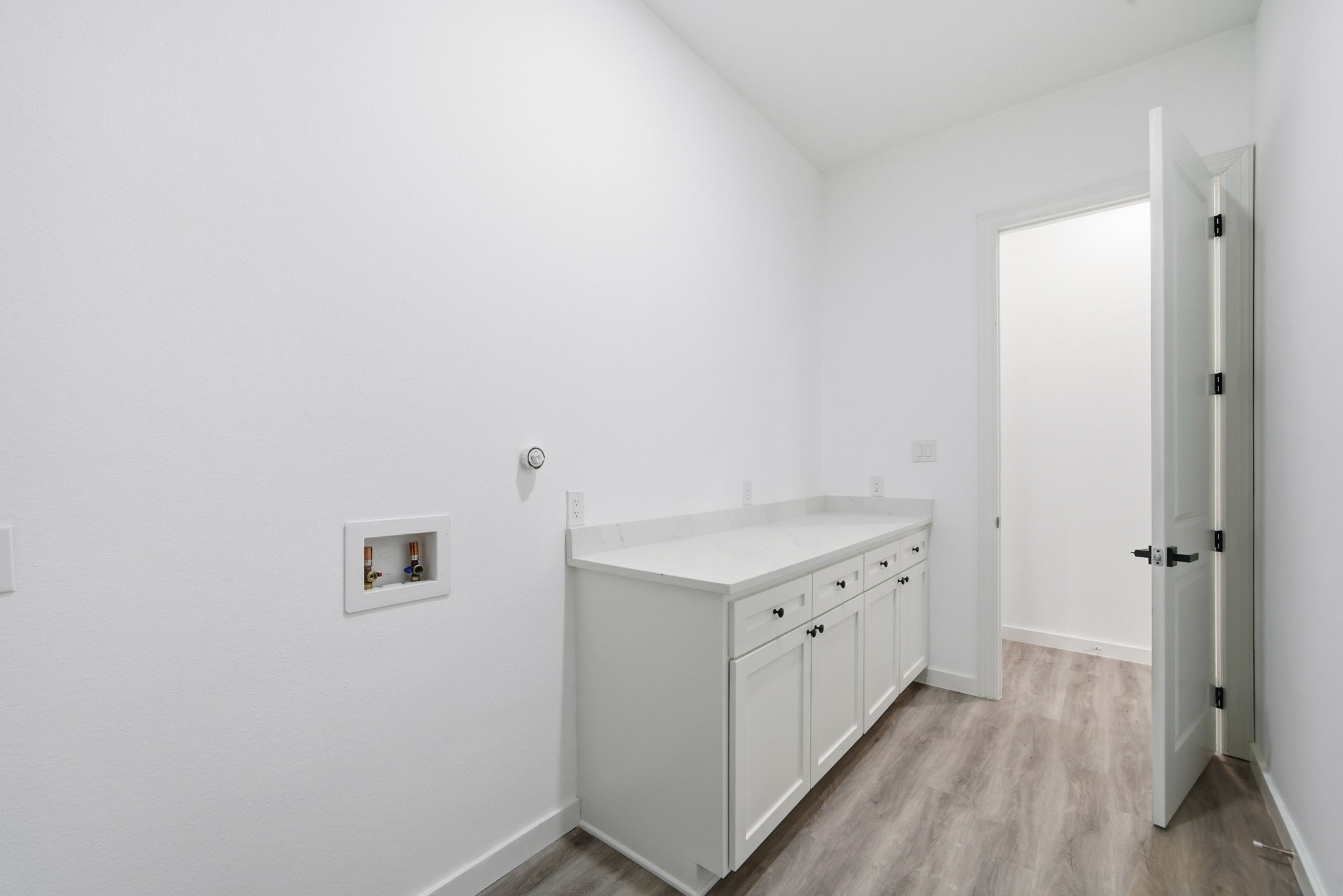 111 Capetown Way Conroe, TX 77356 - Photo 21 of 37 a kitchen with a sink and a refrigerator
