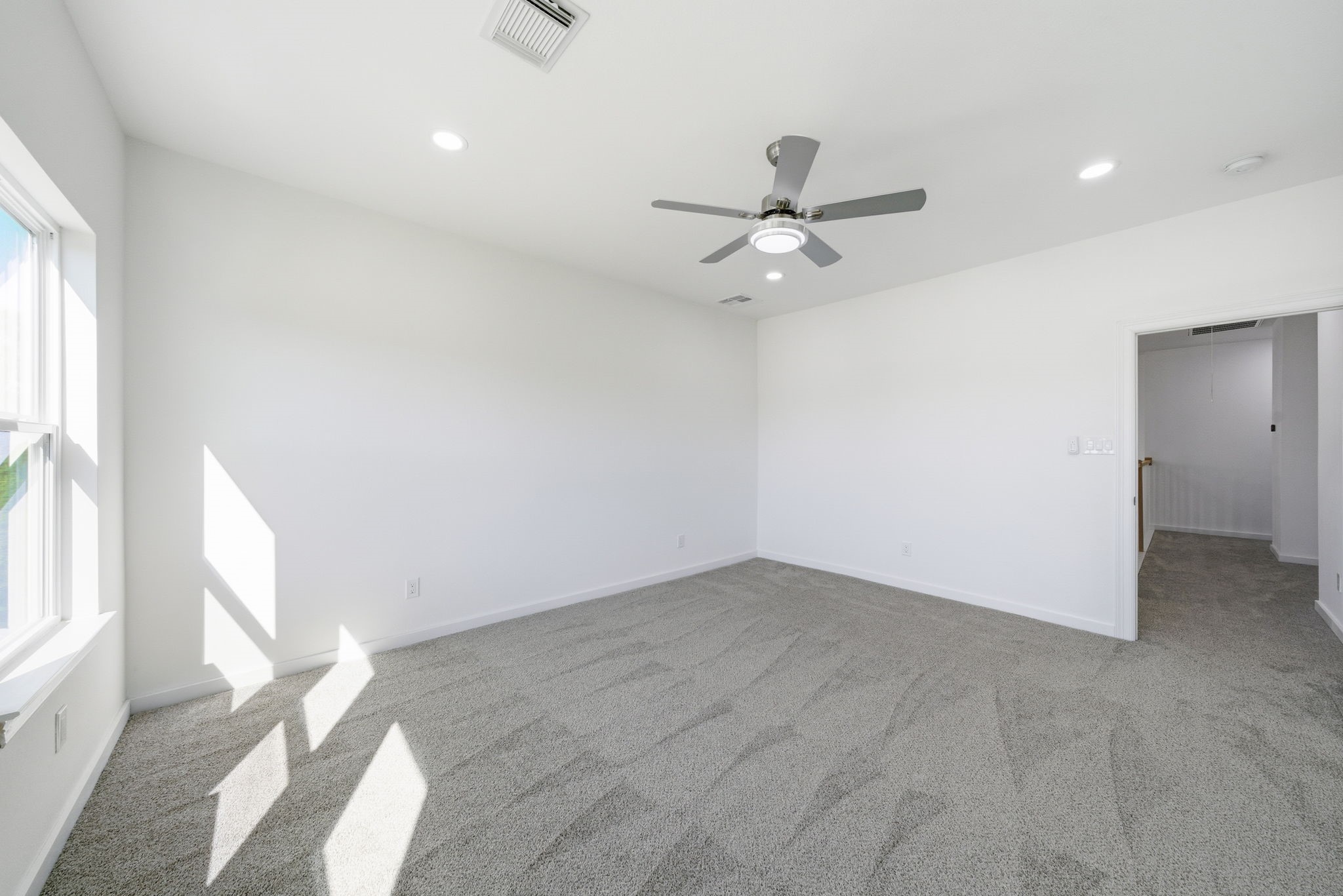 111 Capetown Way Conroe, TX 77356 - Photo 26 of 37 wooden floor in an empty room with a window