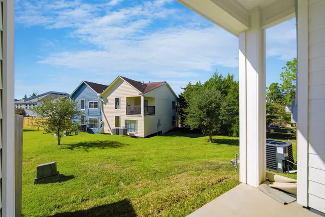 a view of a house with yard and green space