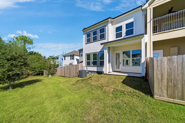 a view of a house with backyard and porch
