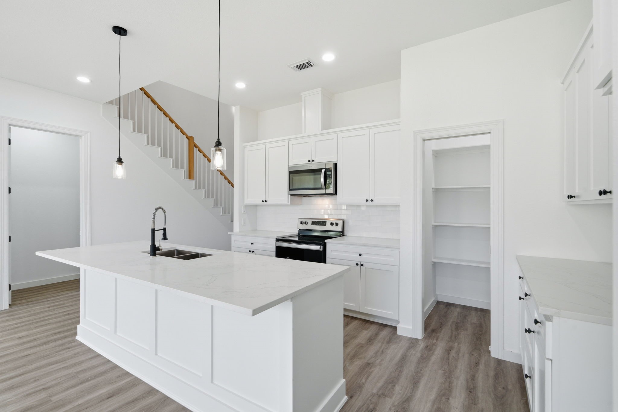 111 Capetown Way Conroe, TX 77356 - Photo 9 of 37 a kitchen with a sink appliances and cabinets