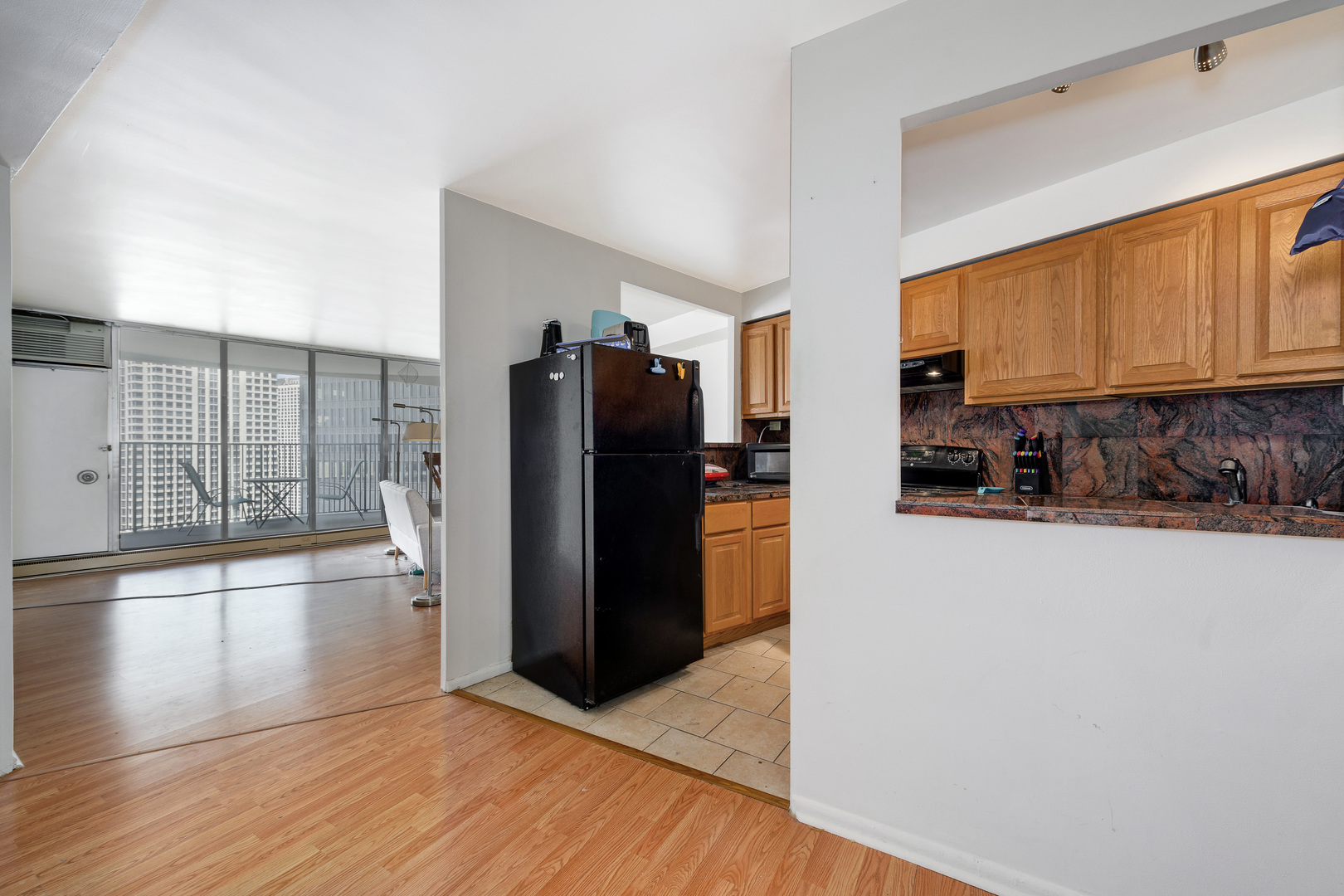 300 North State Street, Unit 3129 Chicago, IL 60654 - Photo 5 of 19 a kitchen with stainless steel appliances granite countertop a refrigerator and a stove