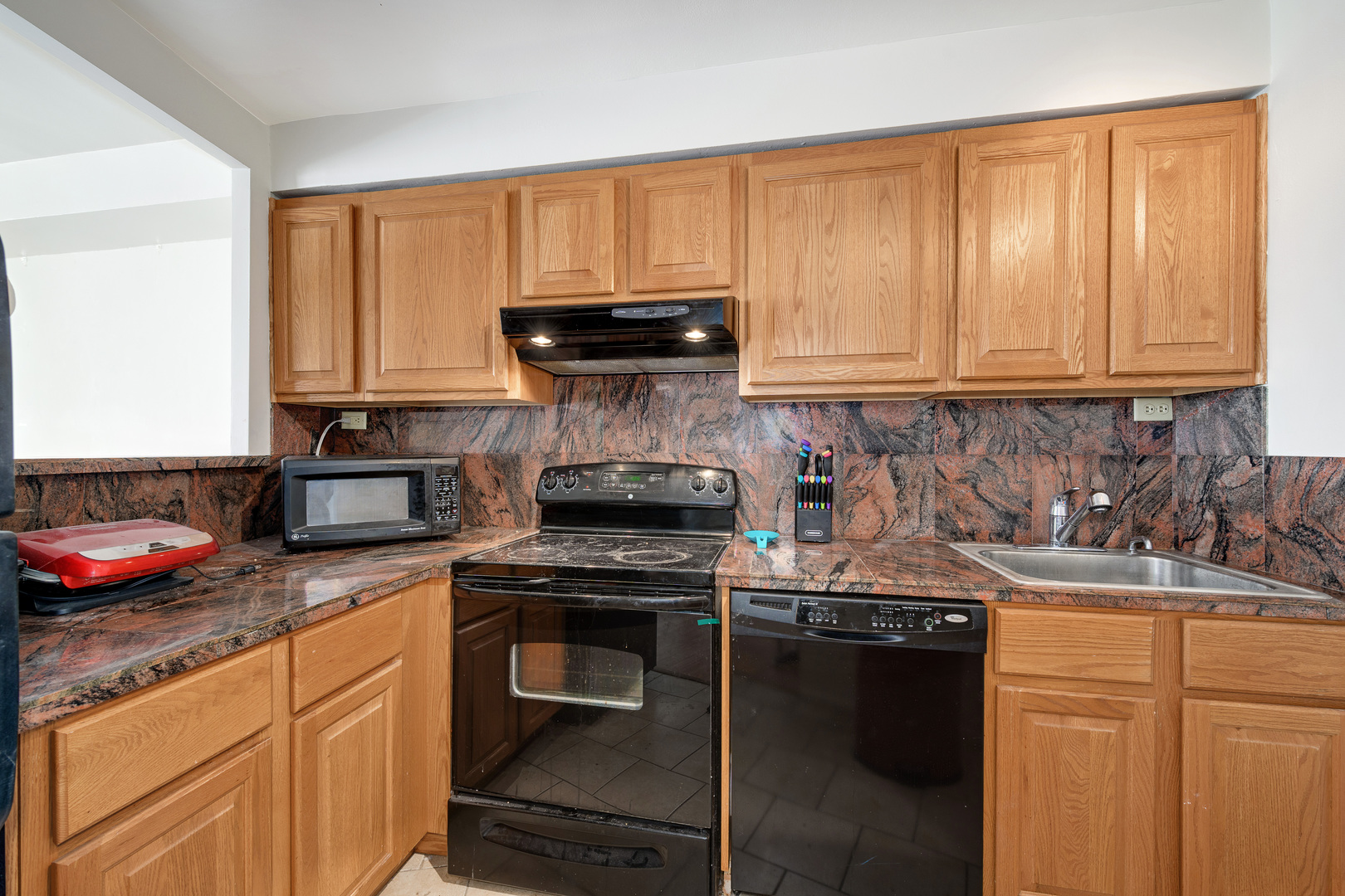 300 North State Street, Unit 3129 Chicago, IL 60654 - Photo 7 of 19 a kitchen with granite countertop a stove sink and cabinets
