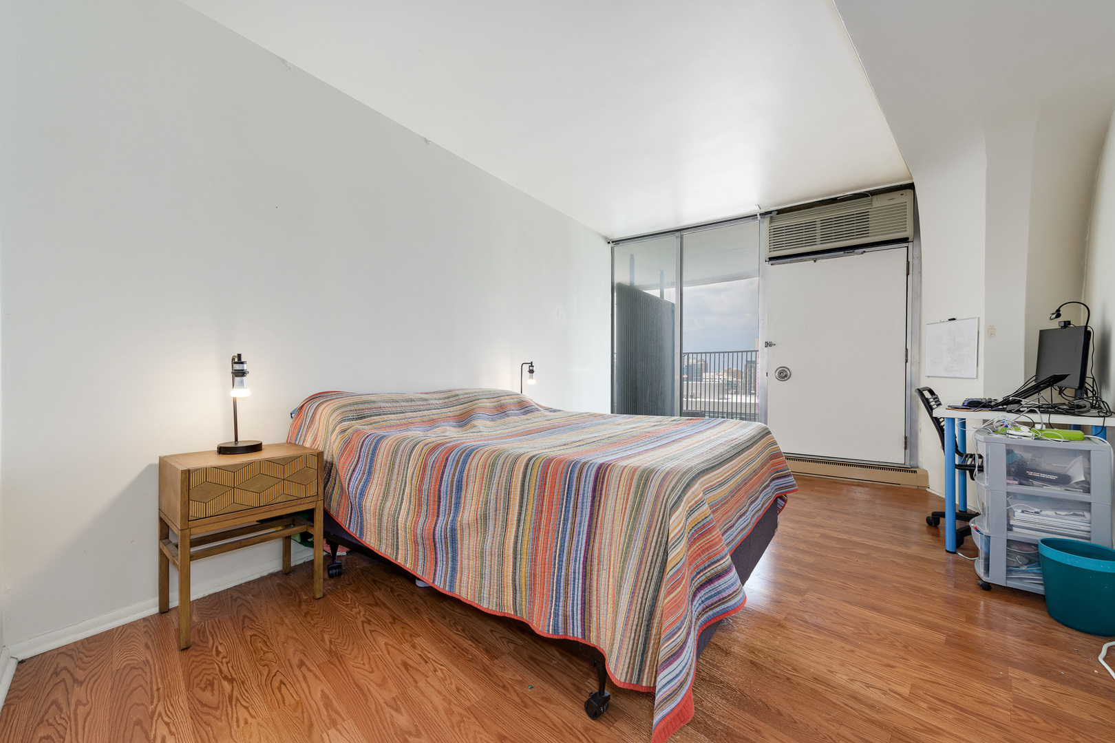 300 North State Street, Unit 3129 Chicago, IL 60654 - Photo 8 of 19 a bedroom with a bed and wooden floor