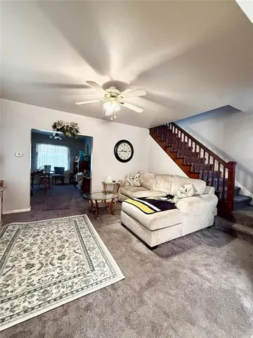 a living room with couch and a rug