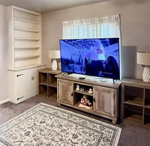 a utility room with stainless steel appliances wooden floor and cabinets