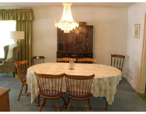 7 Wingate Road Lexington, MA 02421 - Photo 5 of 8 a dining room with a table chairs and a chandelier