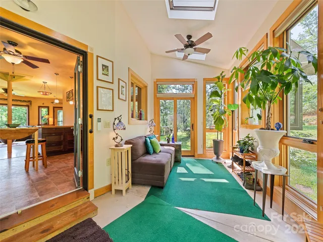 a living room with patio furniture and a floor to ceiling window