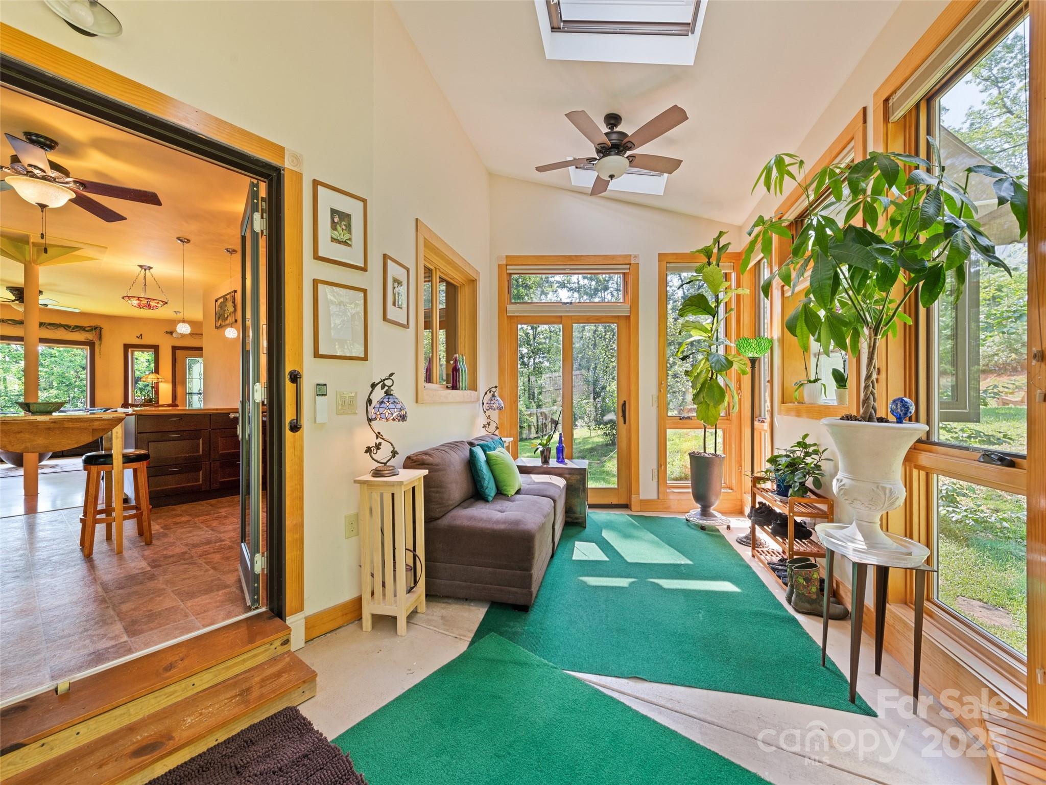 2675 Holbert Cove Road Saluda, NC 28773 - Photo 18 of 48 a living room with patio furniture and a floor to ceiling window