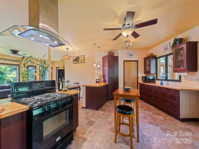 a kitchen with stainless steel appliances granite countertop a stove and a sink