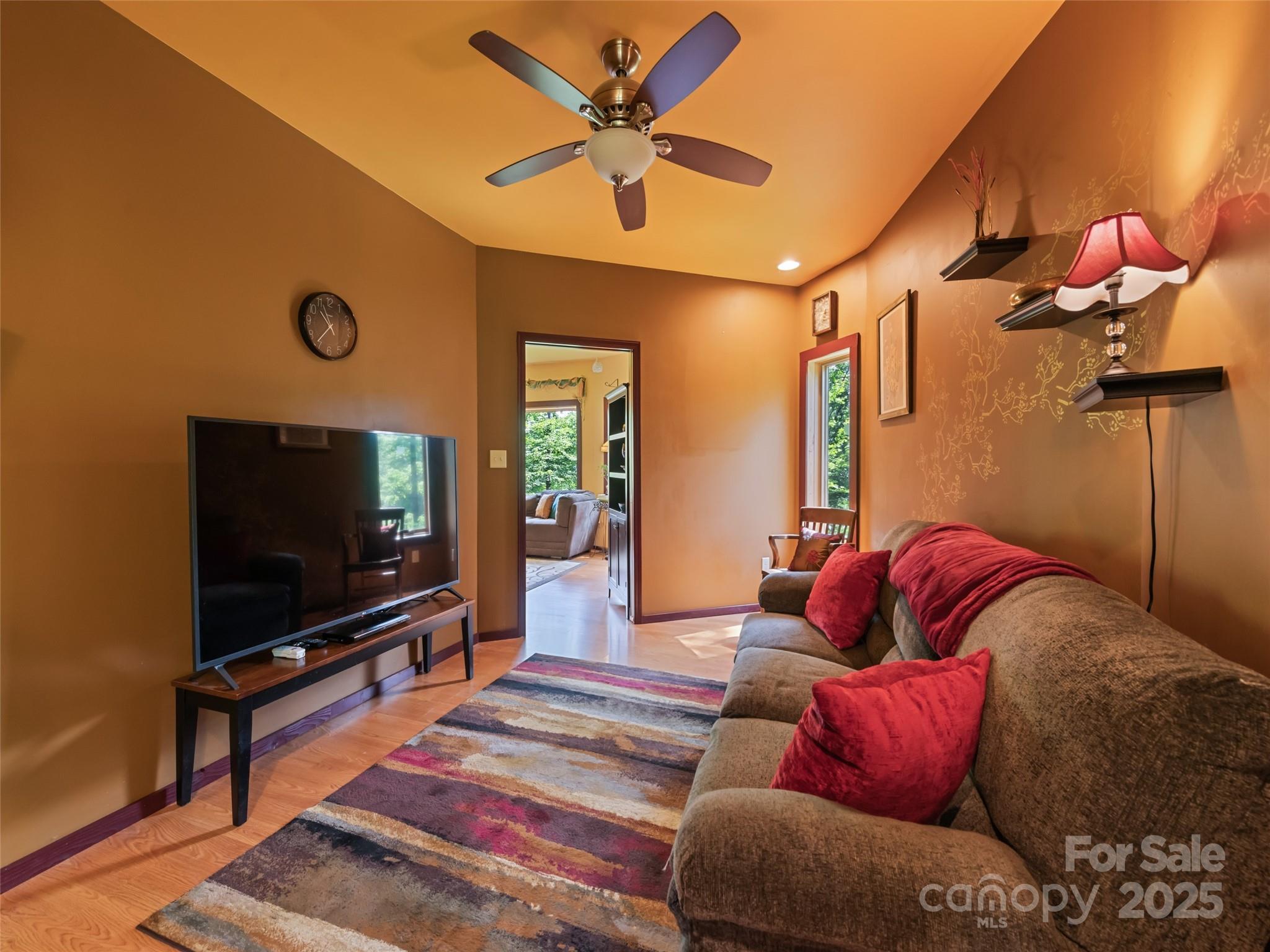 2675 Holbert Cove Road Saluda, NC 28773 - Photo 28 of 48 a living room with furniture and a flat screen tv