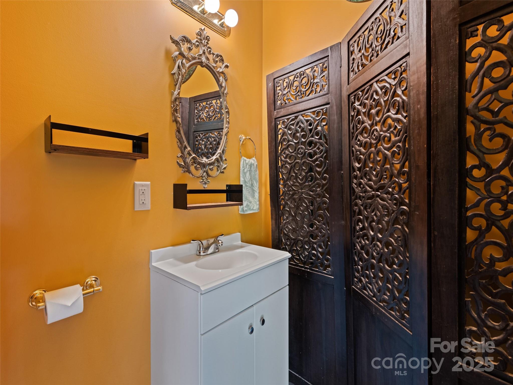 2675 Holbert Cove Road Saluda, NC 28773 - Photo 29 of 48 a bathroom with a sink and a mirror