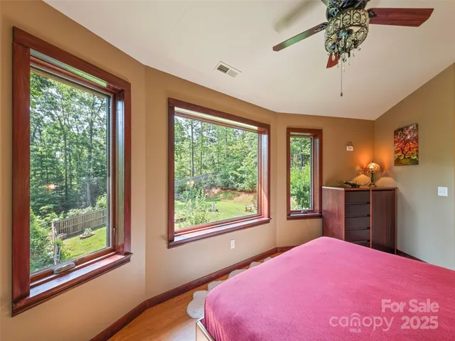 a bedroom with a bed dresser and a window