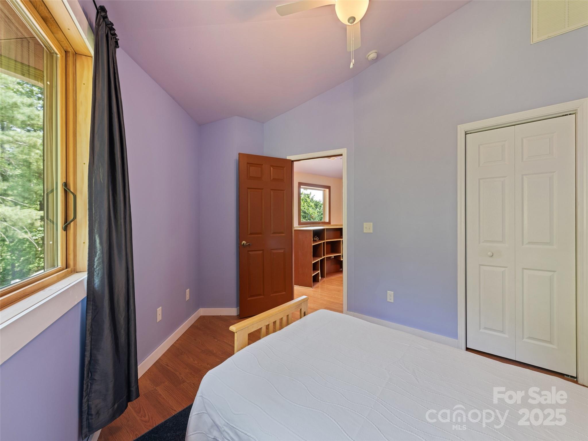 2675 Holbert Cove Road Saluda, NC 28773 - Photo 40 of 48 a bedroom with a bed and wooden floor