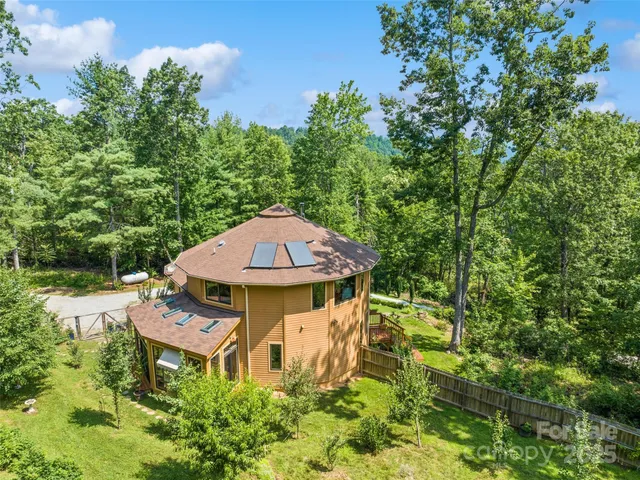 an aerial view of a house with swimming pool and garden