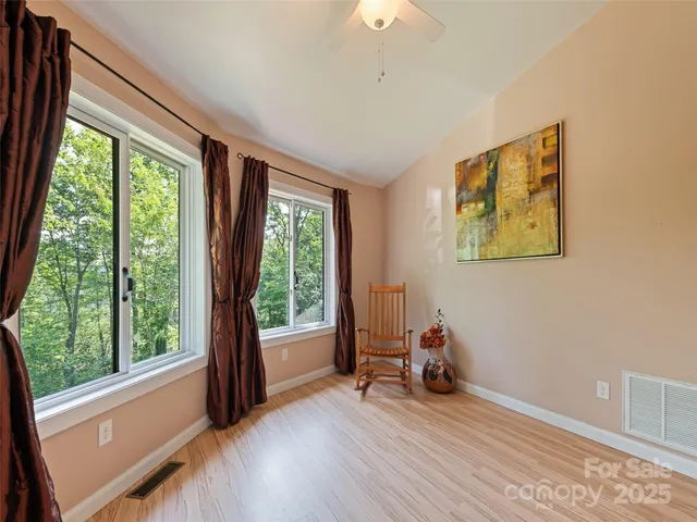 a view of a room with gym equipment and a large window