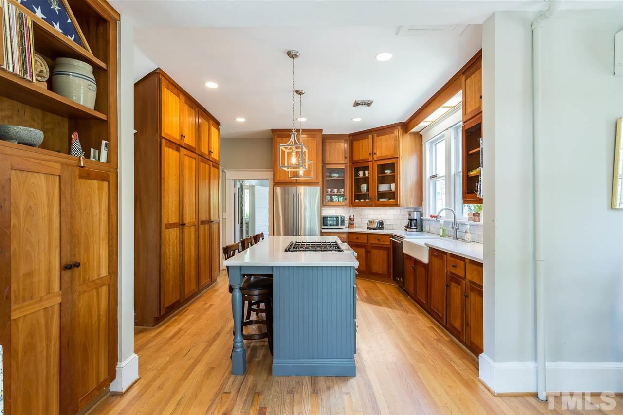 220 North East Street Raleigh, NC 27601 - Photo 22 of 30 a kitchen with stainless steel appliances granite countertop wooden floors and sink