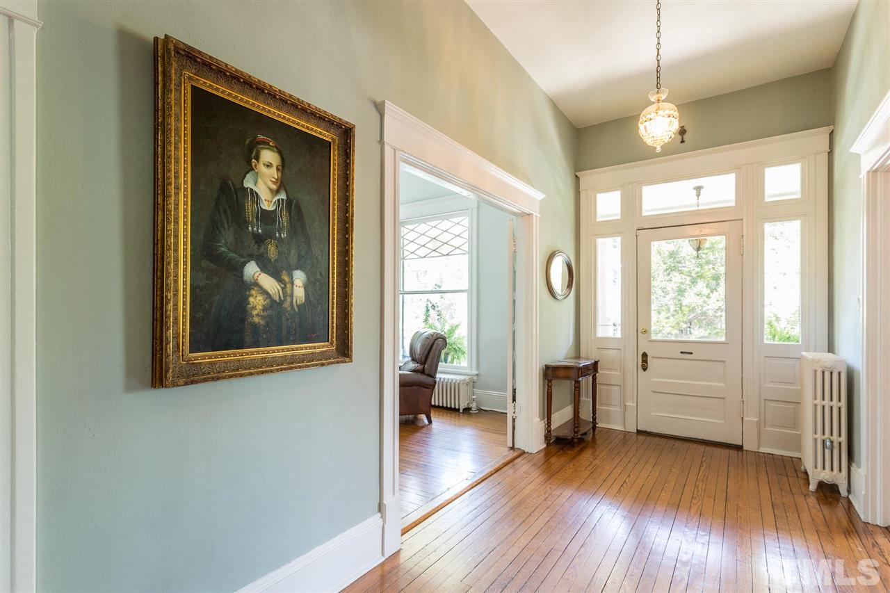 220 North East Street Raleigh, NC 27601 - Photo 10 of 30 a view of a livingroom with furniture wooden floor a ceiling fan and windows