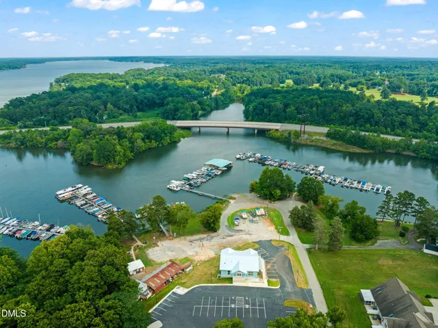 an aerial view of a house with a garden and lake view