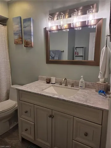 a bed sitting in a bedroom next to a lamp