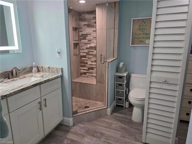 a bathroom with a toilet and a shower