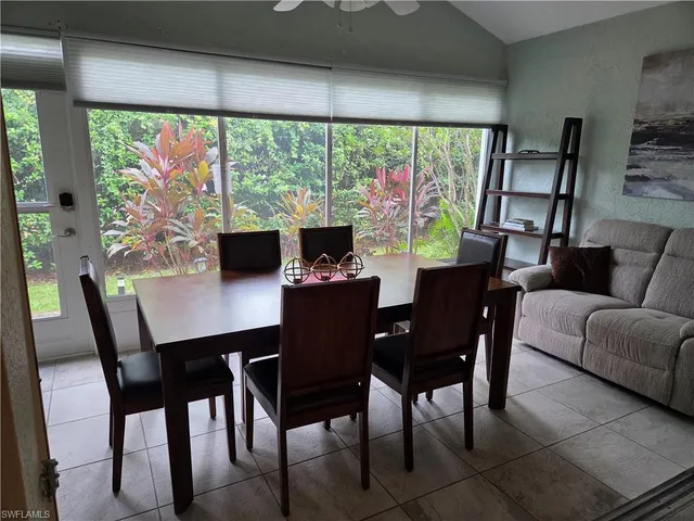 a view of a dining room with furniture large windows and wooden floor