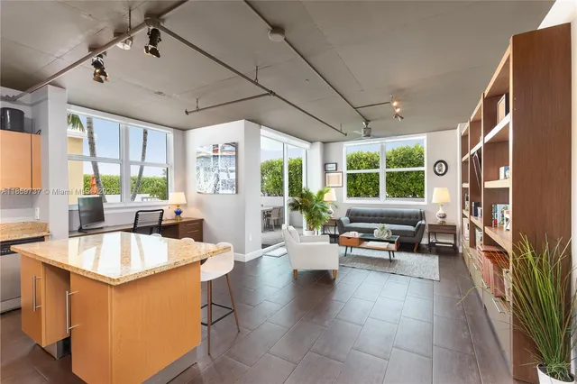 a kitchen with sink refrigerator and large window