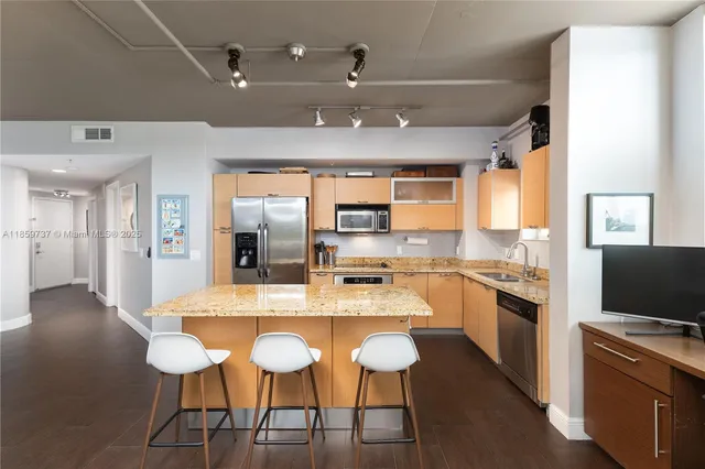 a large kitchen with a table and chairs